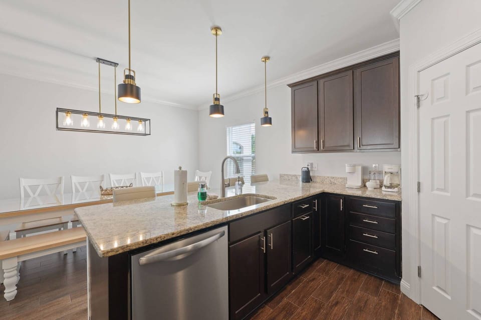 Kitchen: Bright and chic space, with modern lighting and ample prep area for culinary adventures!