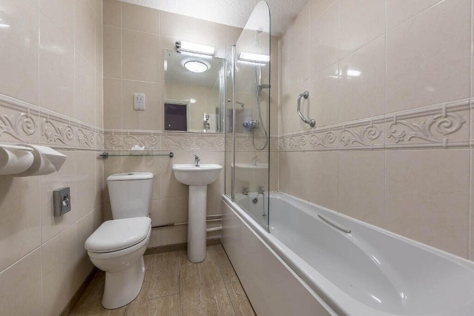 Refresh in a spotless bathroom with a relaxing full bath.