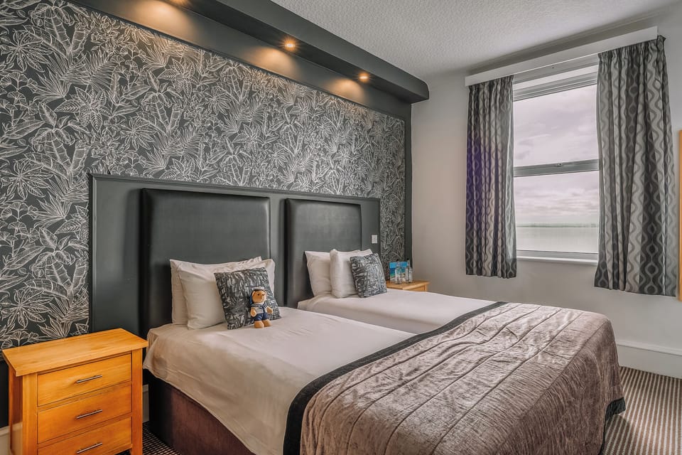 Stretch out in twin beds under warm lights and luxe textures.