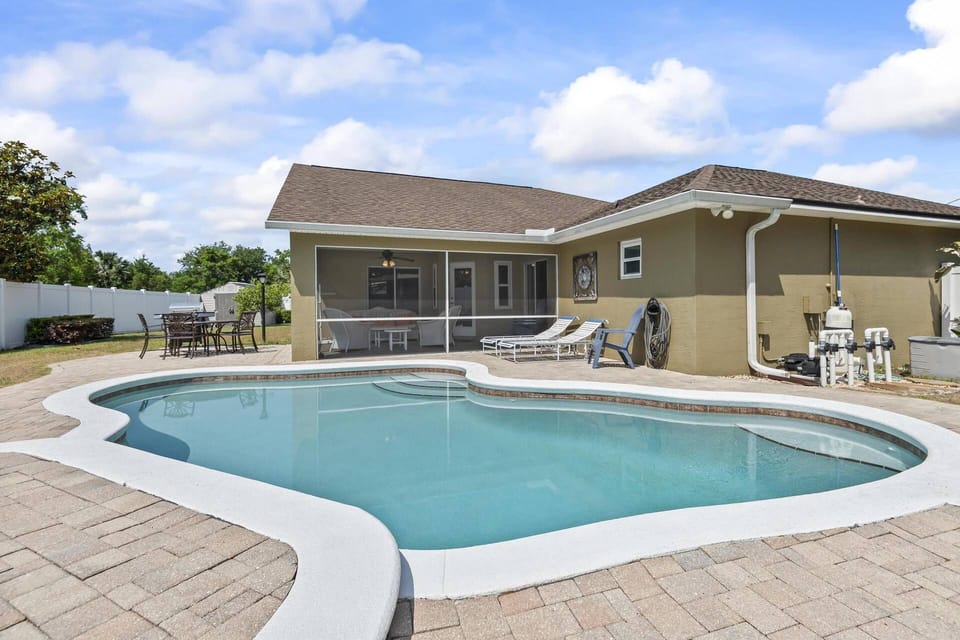 Soak up the sun and cool off in the sparkling pool, complete with comfy loungers—your private Florida retreat awaits!