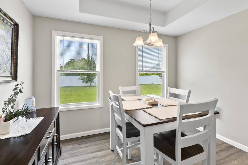 Cozy dining area with a stylish table and seating, ideal for meals and conversations in a bright, welcoming space.
