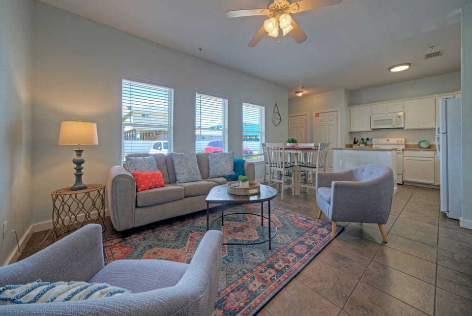The inviting living room boasts plush seating and a smart TV. (Unit 107)