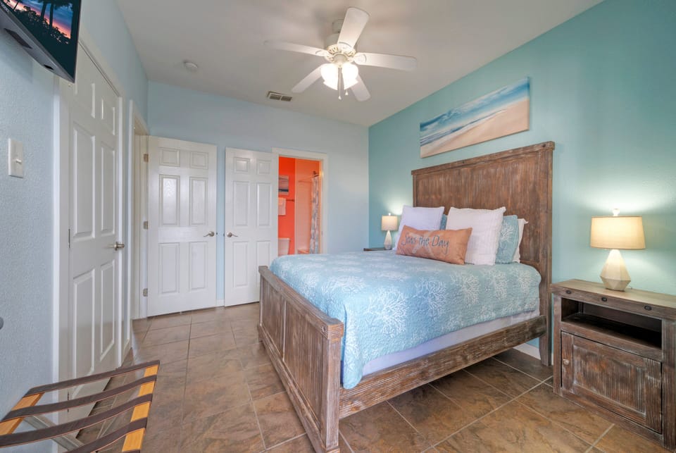 Bedroom 2 features a queen bed, TV and an ensuite bathroom (Unit 109)