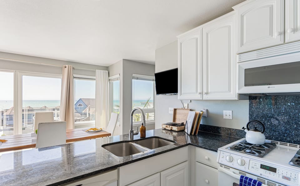 Sleek modern kitchen with ample counter space and appliances. (Cayucan Bungalow 225)