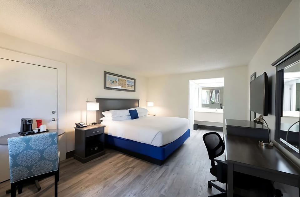 Unwind in a crisp king bed with sleek workspace.