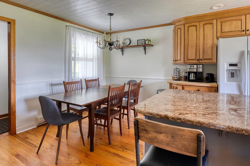 Open, fully stocked kitchen and dining area equipped with all the culinary necessities.