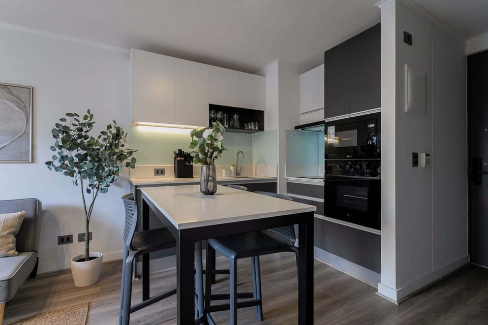 Experience modern living in this sleek kitchen with a stylish island, perfect for casual dining and entertaining.