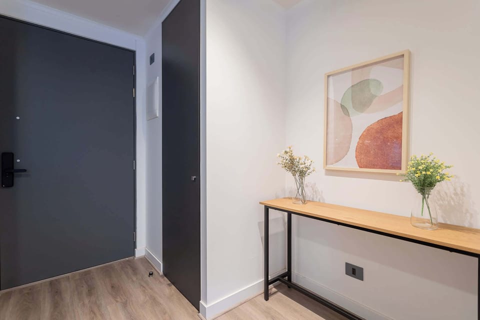 Welcome to your stylish retreat! This modern entryway features minimalist decor and a warm ambiance, setting the tone for a relaxing stay.