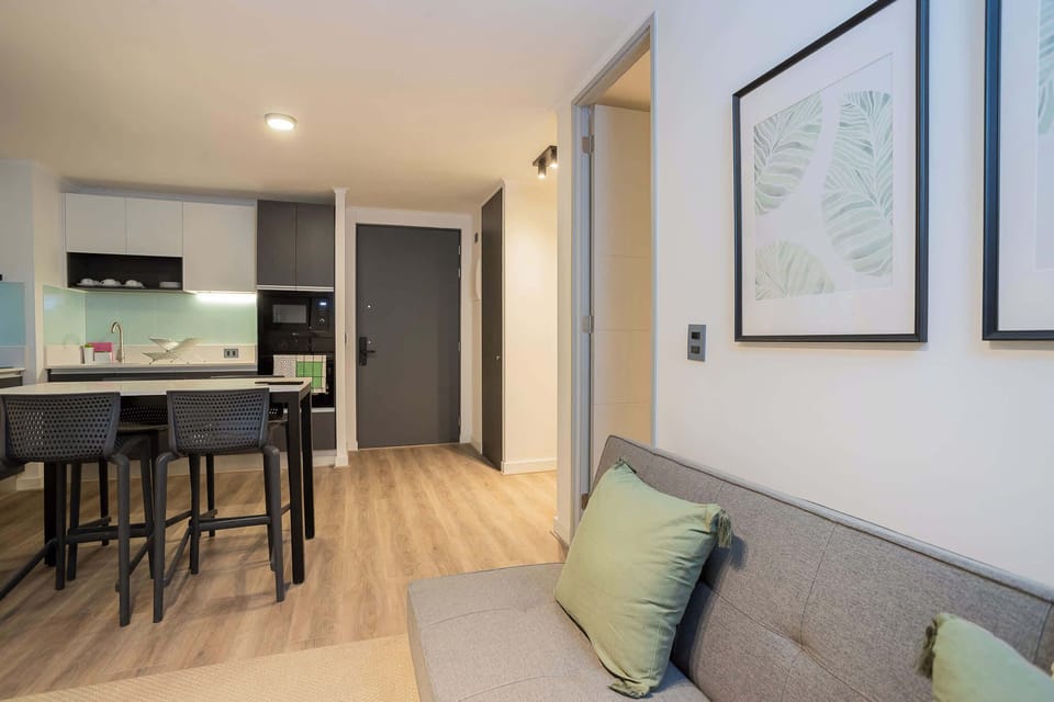 Cozy modern living space with stylish decor and a fully equipped kitchen, perfect for a relaxing stay.