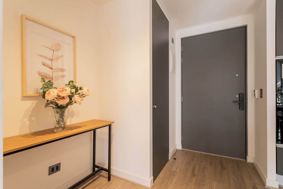 Welcome to your stylish retreat, featuring a charming entryway with elegant decor and a warm ambiance.