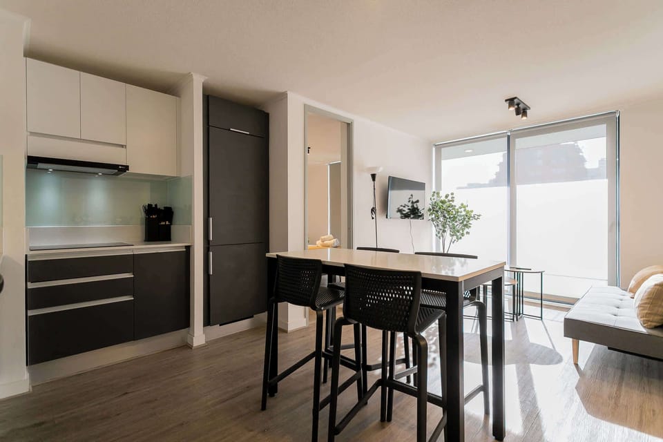 Sleek and modern kitchen with ample natural light, perfect for cozy meals and relaxation.