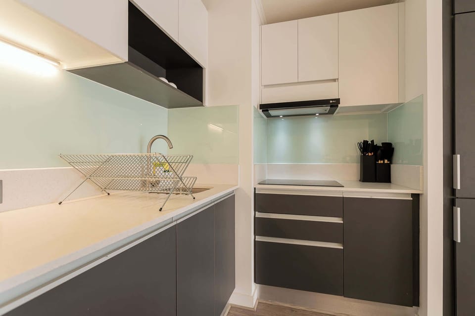 Experience culinary delight in this sleek, modern kitchen with top-notch amenities and stylish design.