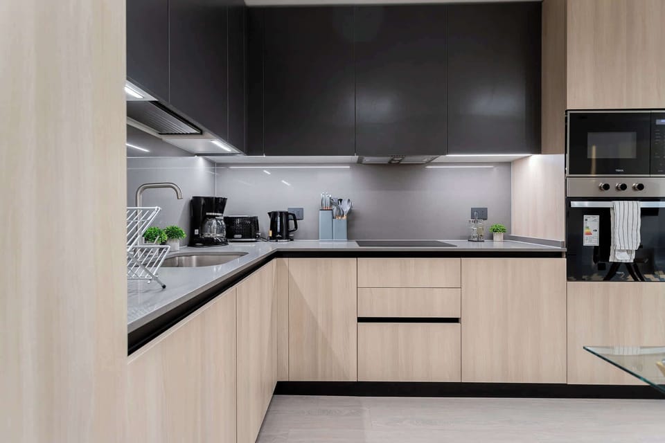 Experience culinary bliss in this sleek, modern kitchen equipped with top-notch appliances and a minimalist design for your cooking adventures.