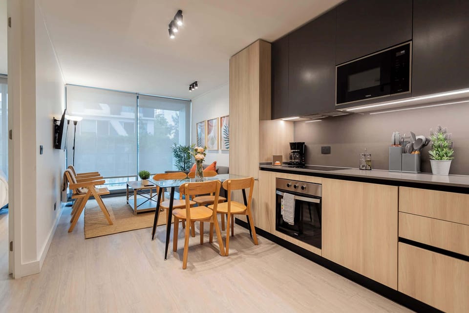Modern kitchen and dining area with sleek design and cozy ambiance, perfect for meals and gatherings.