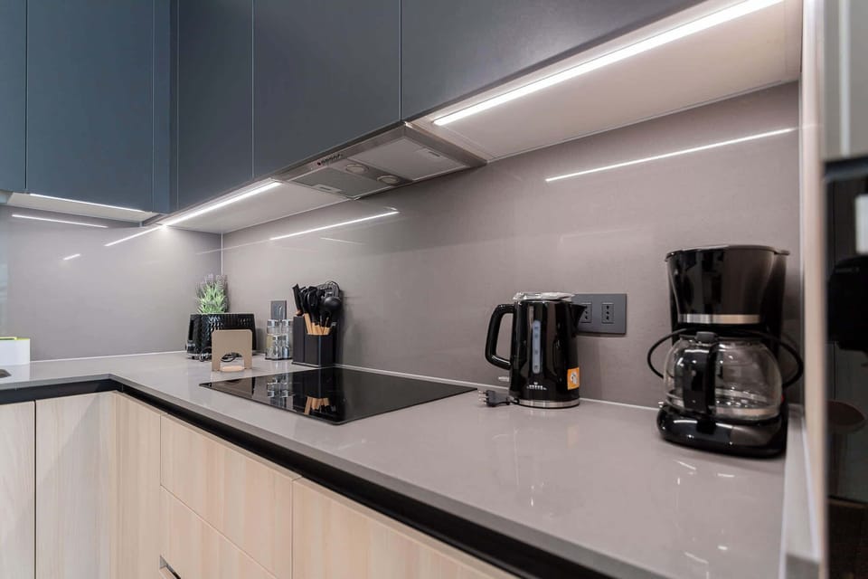Experience culinary delights in this sleek, modern kitchen equipped with top-notch appliances and stylish finishes.