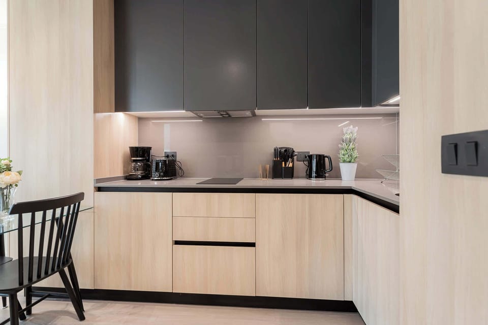 Experience culinary delights in this sleek, modern kitchen featuring high-end appliances and a chic design.