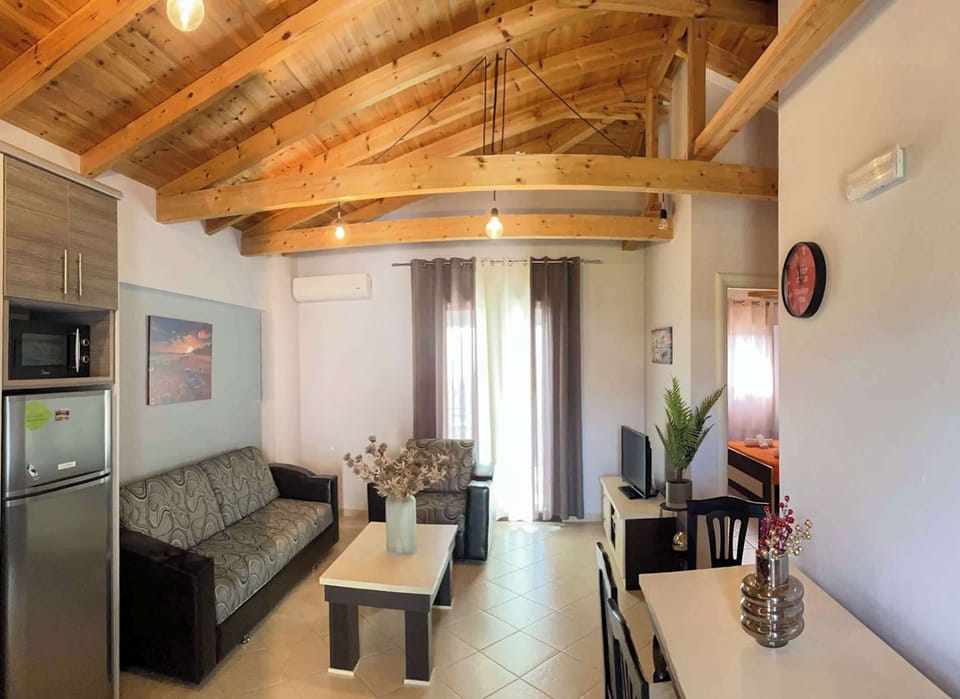 Stylish open-plan living space with natural wood beams, soft lighting, and modern comfort