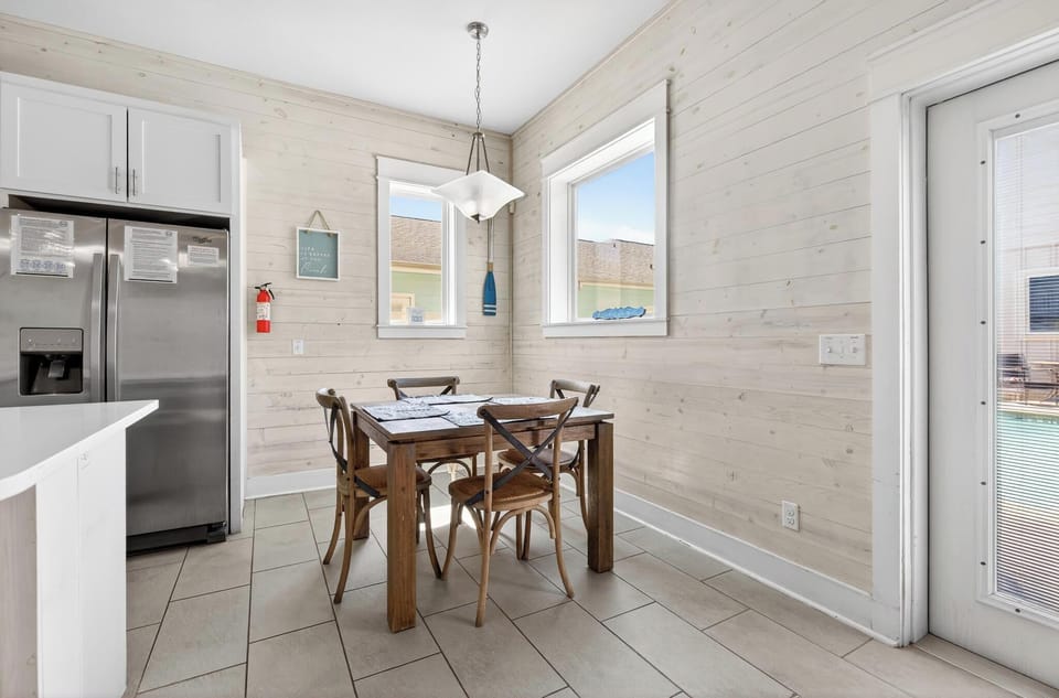 Enjoy meals together in this bright dining space just steps from the kitchen and pool area!