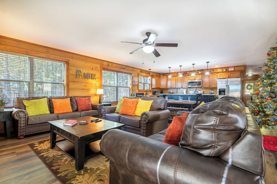 Gather your group in this spacious living room where plush leather seating and vibrant pillows create the perfect spot for relaxation and conversation.