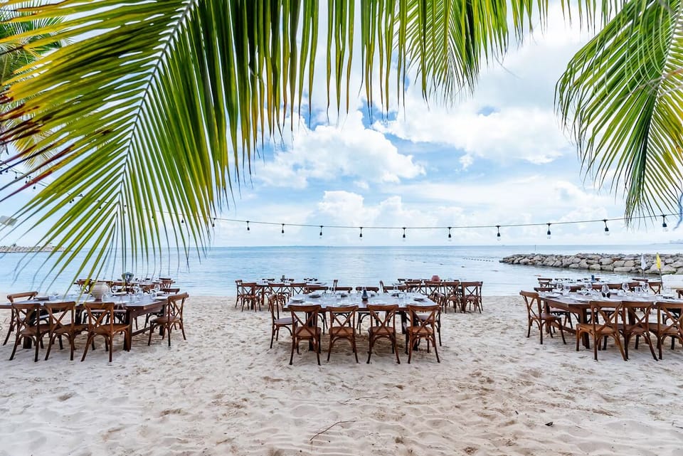 Dine barefoot on the sand with sea views ahead.