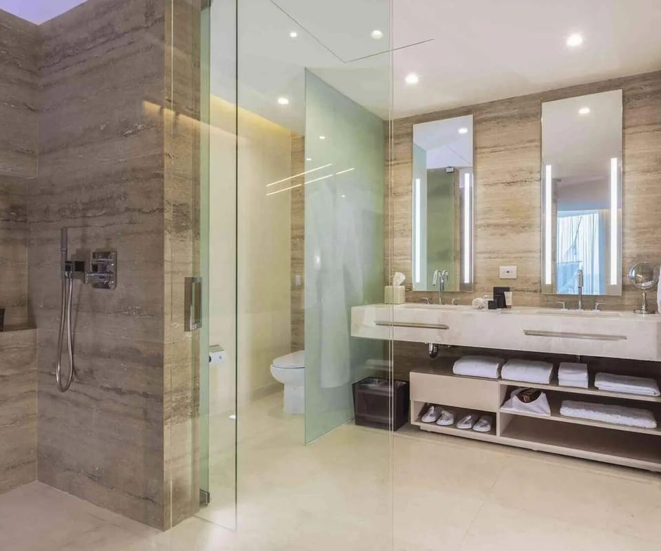 Refresh in the spa-like marble bathroom with glass shower.