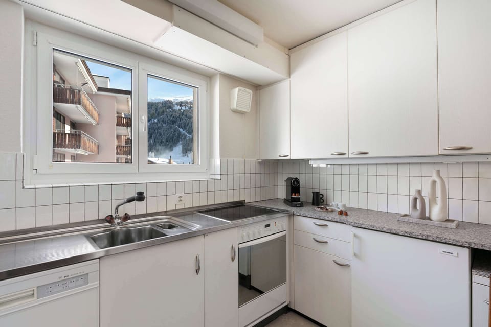 Fully Equipped Kitchen with Alpine Views Cook up your favorites in the functional kitchen, complete with a stove, oven, dishwasher, and mountain-view window.