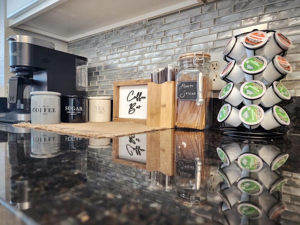 Coffee bar has drip coffee/k-cup combo. Starter supply of k-cups, teas, sugars.