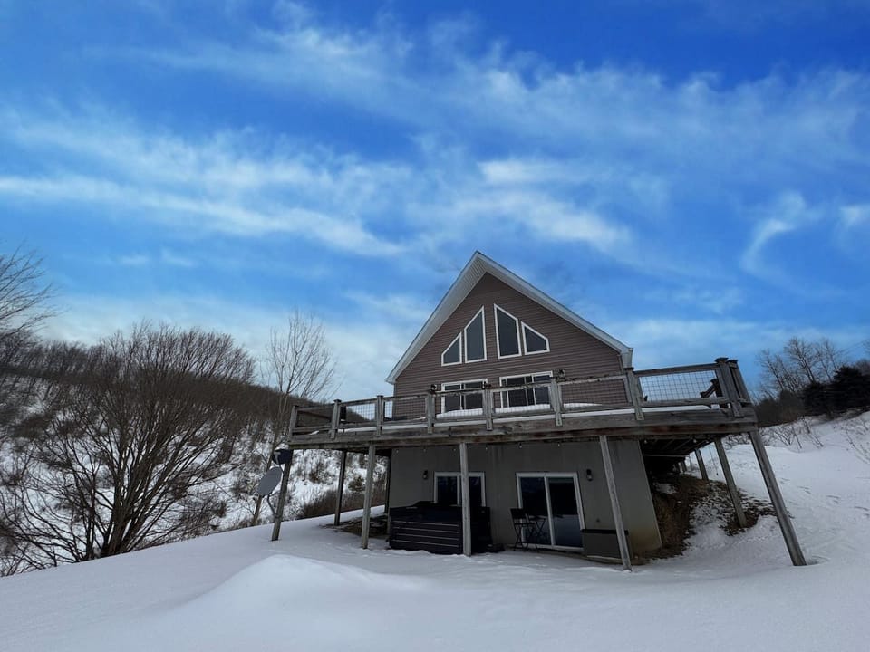 Exterior, deck side: A-frame chalet with a wraparound deck