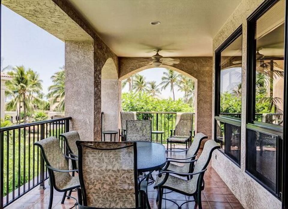 Relax on this covered balcony with tropical views, ideal for dining al fresco or enjoying a serene morning.