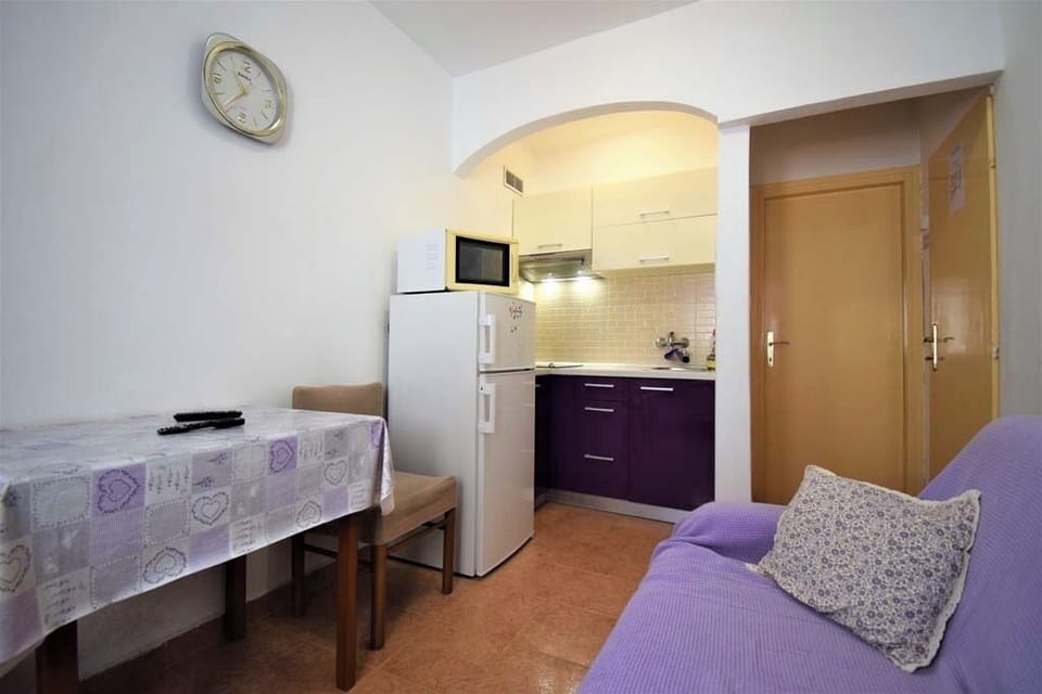 Living room with dining area and kitchenette.