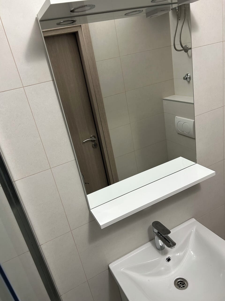 Bathroom sink with mirror and storage.