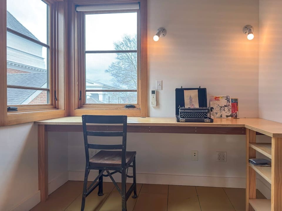A quiet and bright workspace, perfect for productivity, with views of the neighborhood.