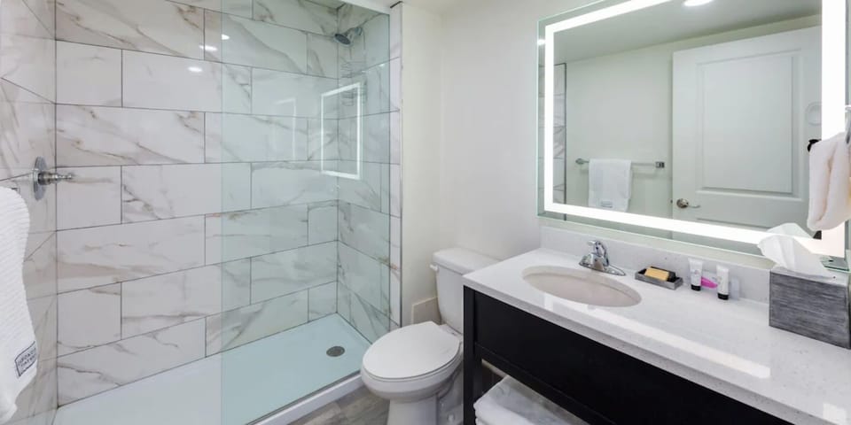 Rinse off in a sleek, marble-tiled walk-in shower.