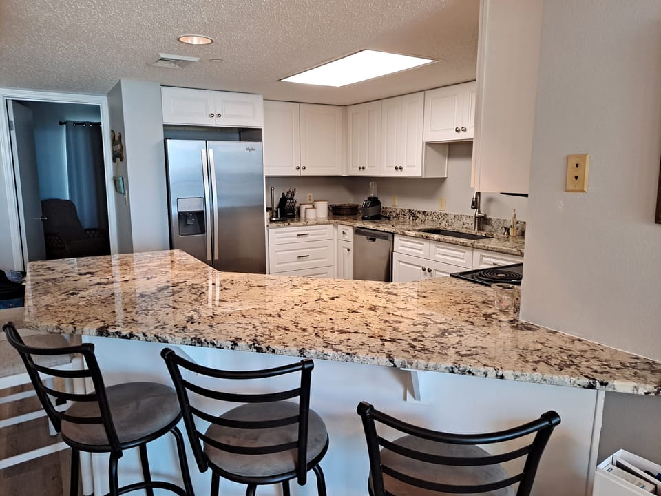 Large kitchen with breakfast bar! Fully stocked for your convenience. 