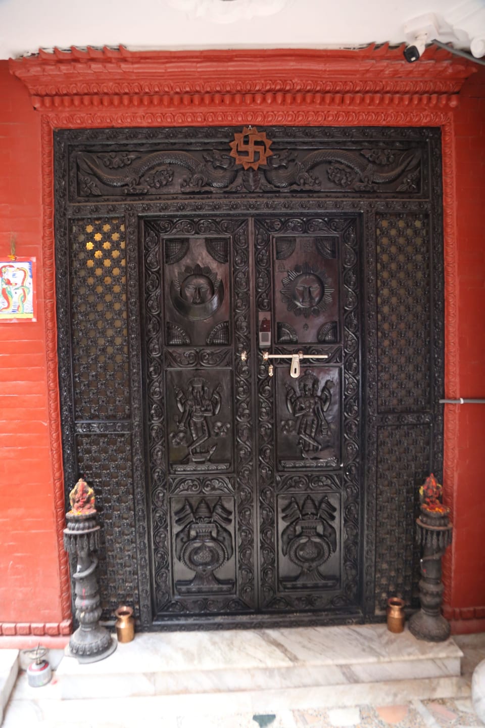 The entrance of Nest Heritage Home features a hand-carved Nepali door, crafted over three months with traditional artistry and spiritual care — a true reflection of Nepal’s rich architectural heritage.”