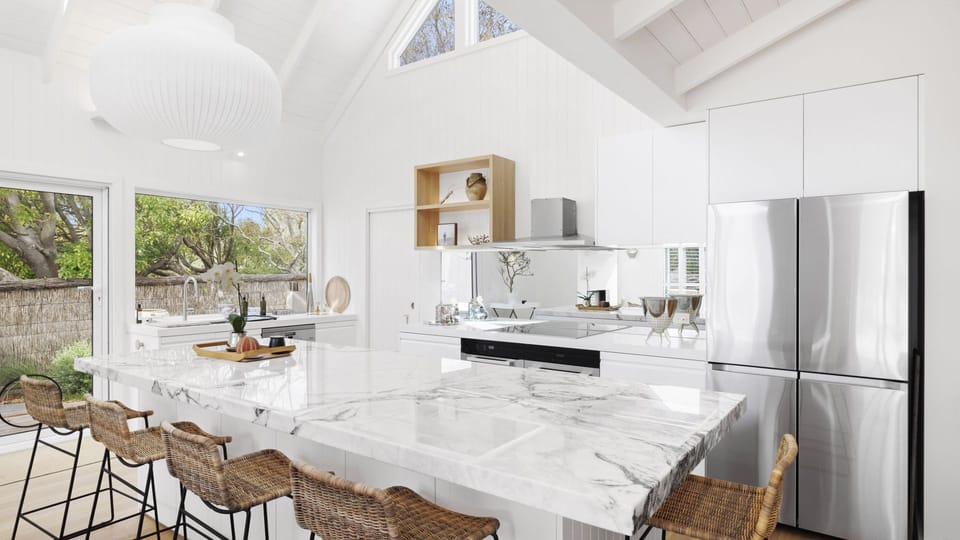 Kitchen with marble island bench and five stools