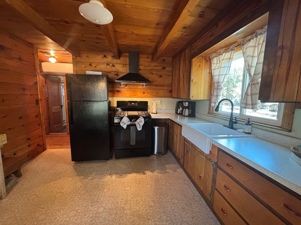 Kitchen with coffee maker, air fryer, fridge and gas stove