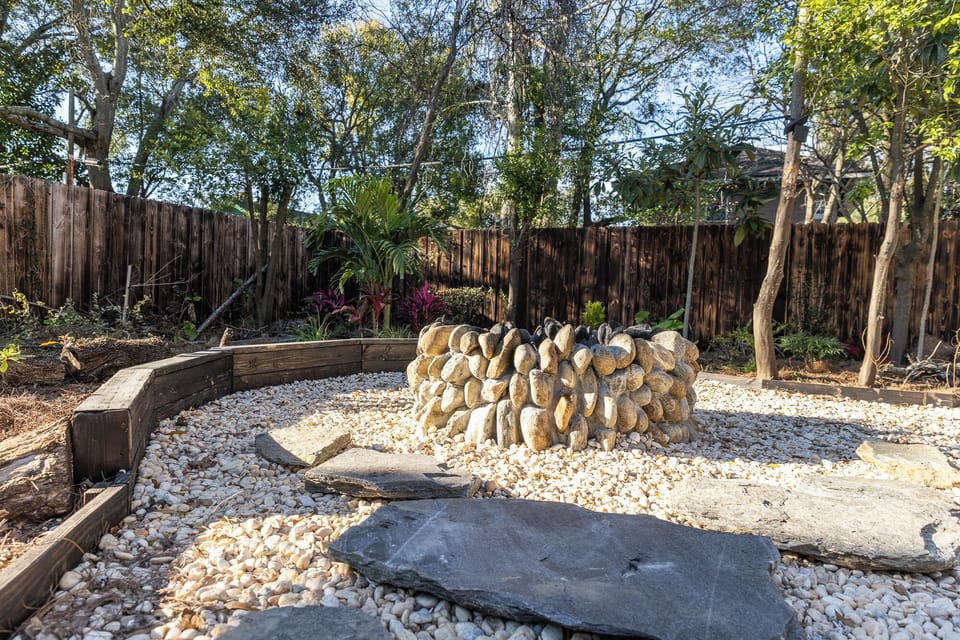 Family friendly backyard with tree fort and fire pit.