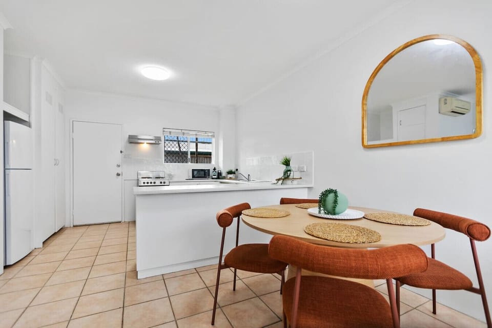 The dining area offers a comfortable space to enjoy meals together, featuring a stylish table with seating for four. Perfect for family dinners, casual breakfasts, or working on your laptop in a bright, open-plan setting.