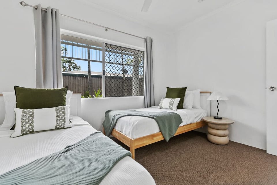 Enjoy restful nights in this twin bedroom with two comfortable single beds, quality linens, and a welcoming feel. Great for families or group stays, offering flexibility and comfort in a tropical setting.