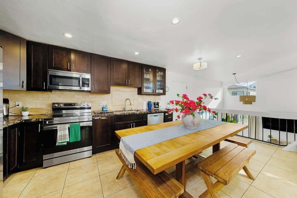 A fully stocked kitchen with ample seating combines functionality and comfort. A large dining table with seating accommodates larger gatherings.