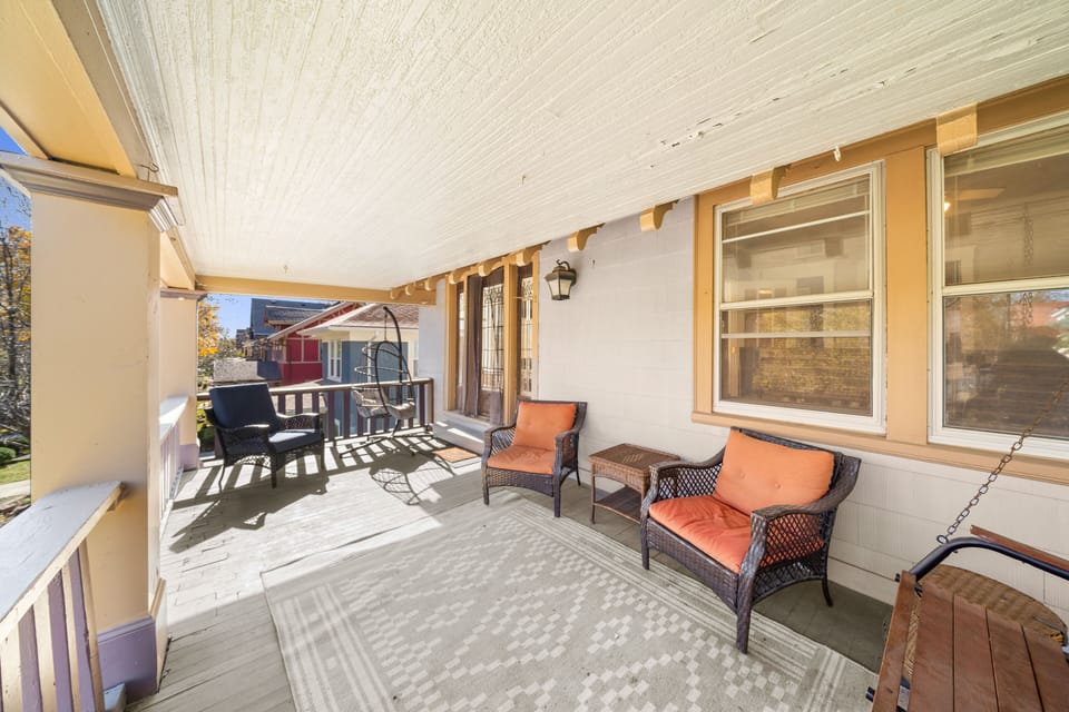 Spacious covered porch with outdoor seating — ideal for morning coffee or evening unwinding.