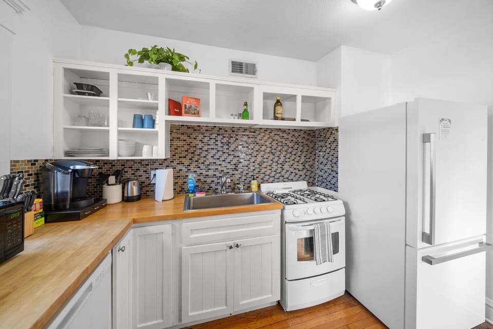 Bright functional kitchen workspace with modern appliances and storage.