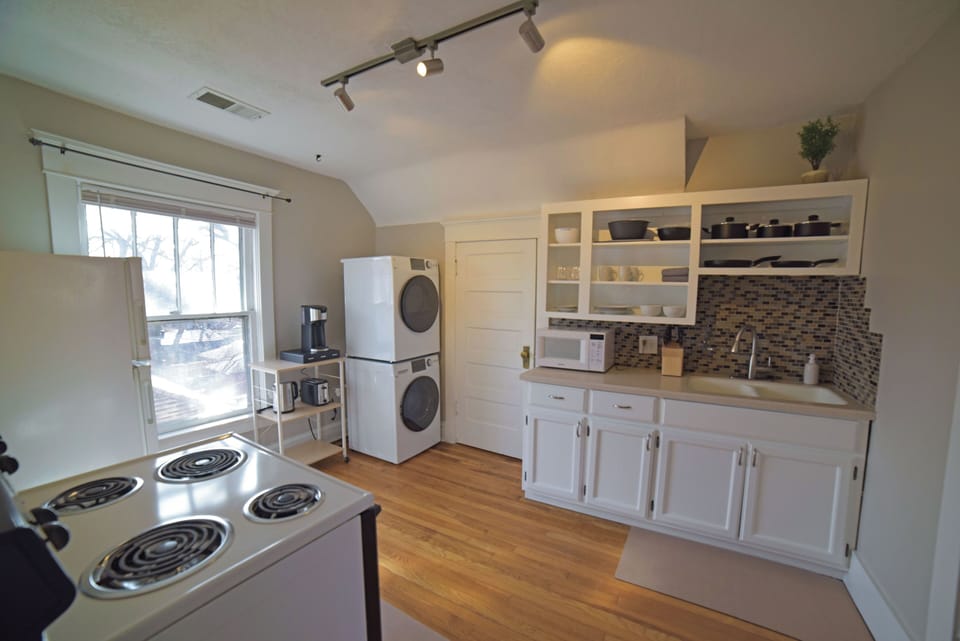 Functional kitchen space equipped for everyday cooking, with convenient in-unit laundry access.