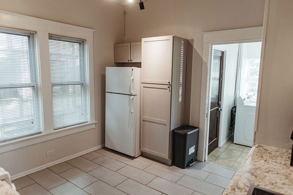 Full-size refrigerator and pantry storage, ideal for longer stays and furnished monthly rentals.