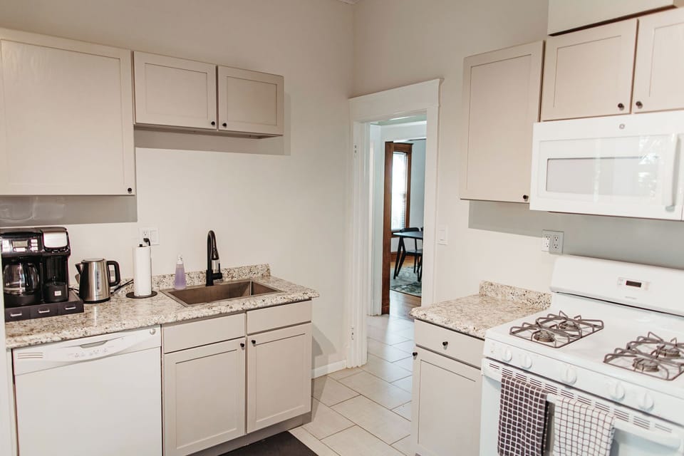 Well-appointed kitchen layout with dishwasher, coffee bar, and easy flow into the living areas.