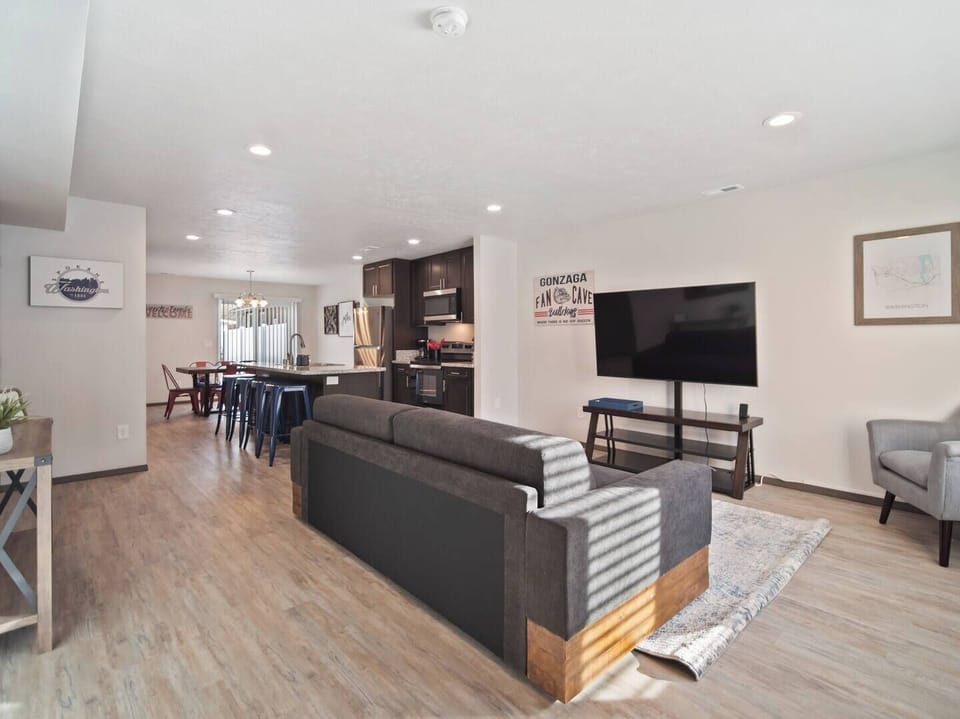 The living space has a sofa and smart TV. The sofa has a trundle bed beneath it (twin) and the sofa seat itself is twin-bed sized.
