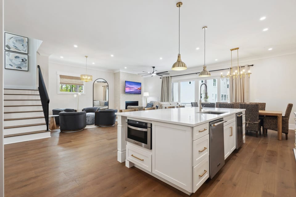 The Chef's kitchen boasts a large island with a double dishwasher, a huge fridge, and modern high-end appliances, making it ideal for cooking and entertaining.