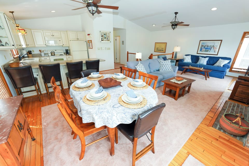 50 S. Anchorage - Open Dining Area - Spacious open-concept area featuring a round dining table with seating for six, beautiful hardwood floors, and a bright view into the main living room.