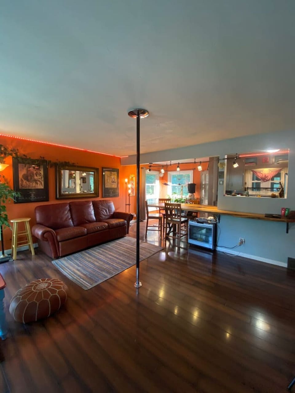Comfy Living room with leather couch and fitness pole
